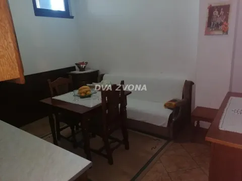 Small living room with a dining table and a sofa. - image 12