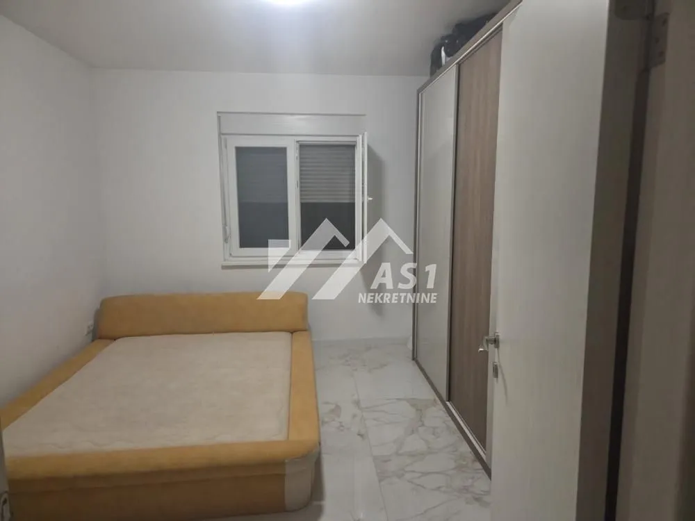 Bedroom with a double bed and a fitted wardrobe.