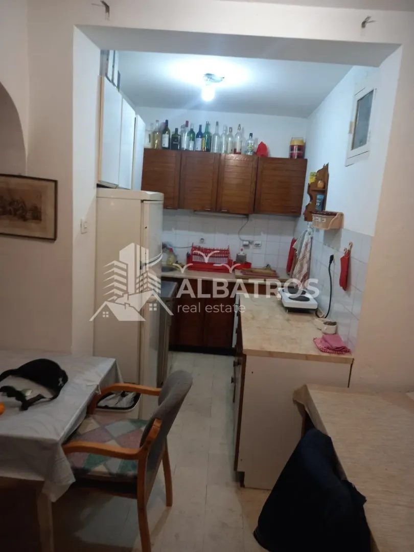 Smaller kitchen with wooden cabinets and a dining table.