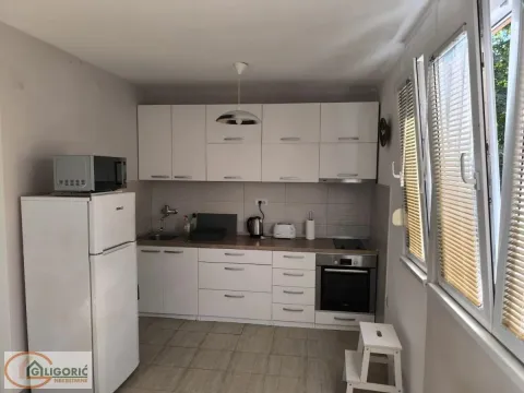 Small white kitchen with all built-in appliances and a refrigerator. - image 4