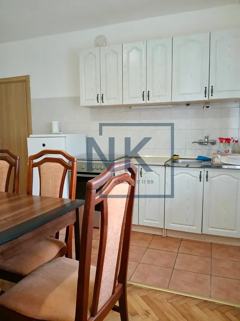 Kitchen with dining area and white cabinetry.