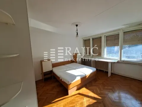 Furnished bedroom with a double bed and parquet flooring. - image 5
