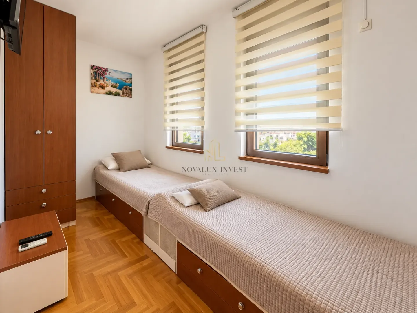 Small bedroom with two single beds and a built-in wardrobe.