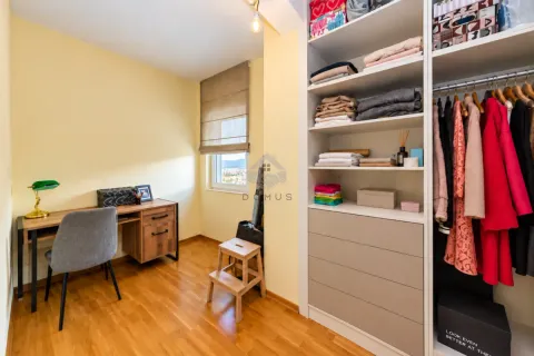 Small room with a desk and a large built-in wardrobe. - image 26