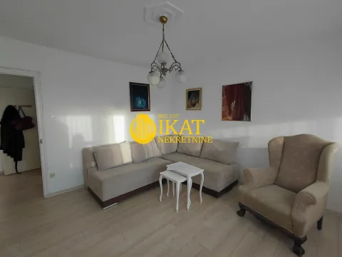 Living room with a corner sofa, armchair, and paintings on the wall. - image 14