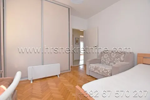 Furnished bedroom with a bed, armchair, and wardrobe. - image 13