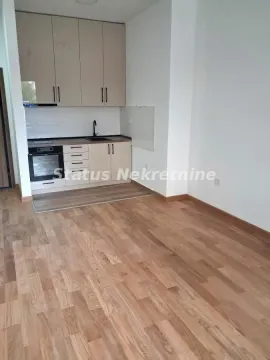 Small kitchen with light-colored cabinetry and wooden flooring in an apartment. - image 13
