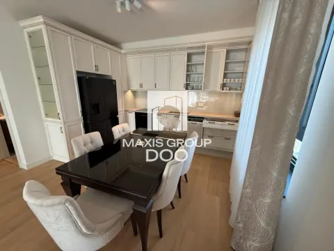 Kitchen with a dining area and elegant white cabinetry. - image 9