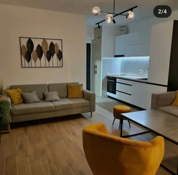 Living room with a sofa and dining area in an open-plan layout. - image 3