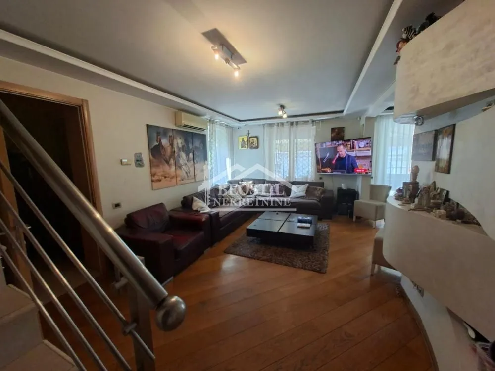 Spacious living room with seating area and television.