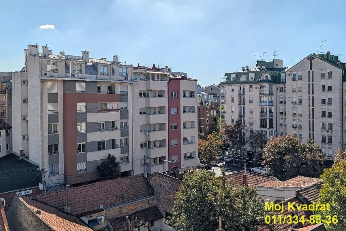 View from the window overlooking surrounding buildings and the cityscape.