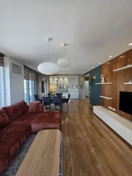 Spacious living room with a sofa set, dining area, and kitchen in the background. - image 5