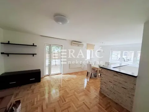 Spacious living room with a dining area and parquet flooring. - image 3
