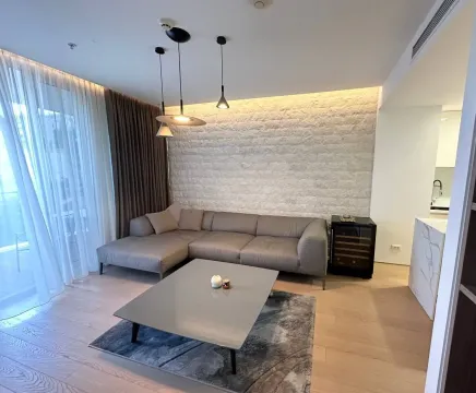 Modern living room with a sectional sofa and decorative lighting. - image 3