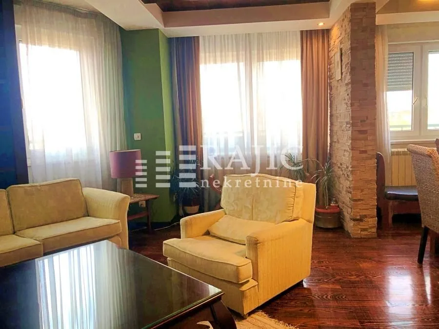 Living room with seating furniture and dining area.