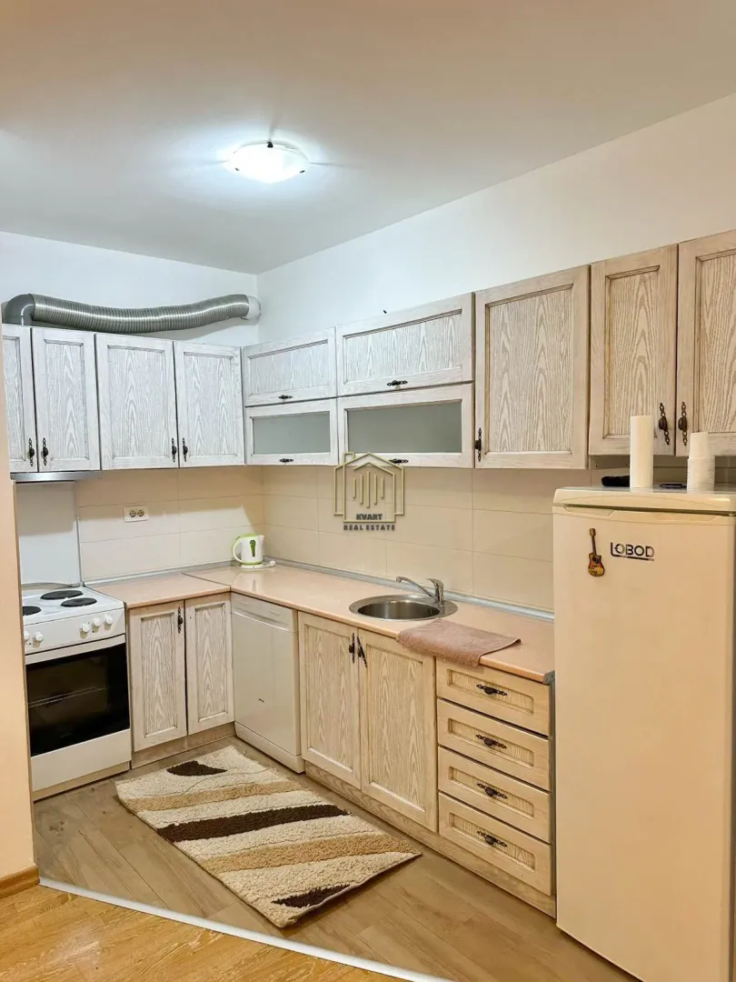 Smaller kitchen with wooden cabinets and basic home appliances.