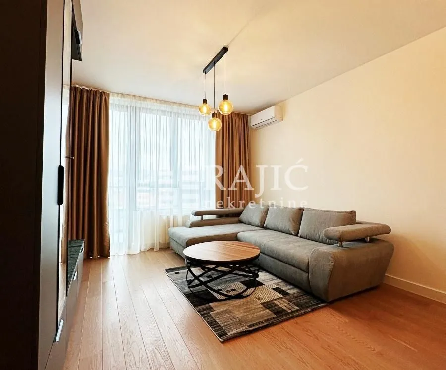 Comfortable living room with a sectional sofa and a large window.