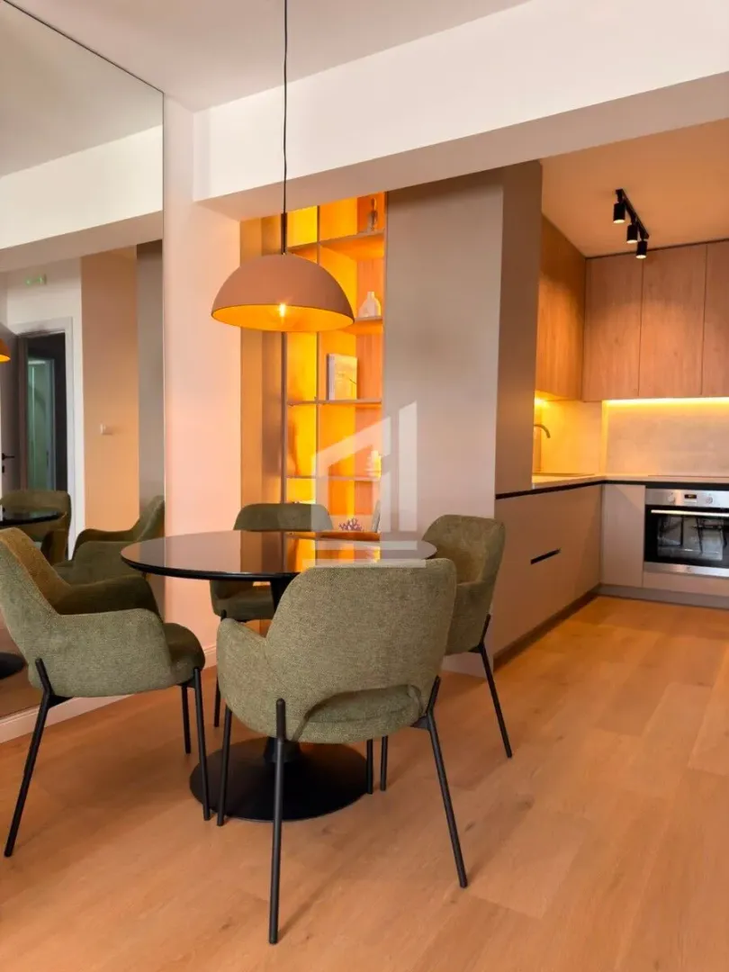 Modern kitchen with dining area and built-in units.