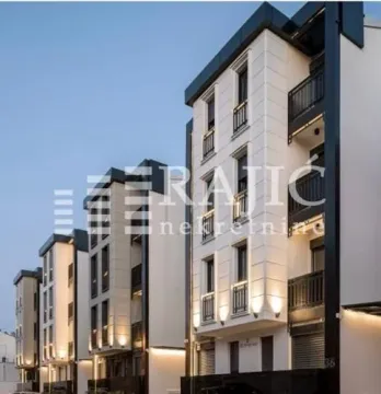 Exterior view of a modern multi-family building with lighting. - image 5
