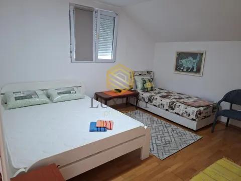 Attic bedroom with two beds and wooden flooring. - image 2