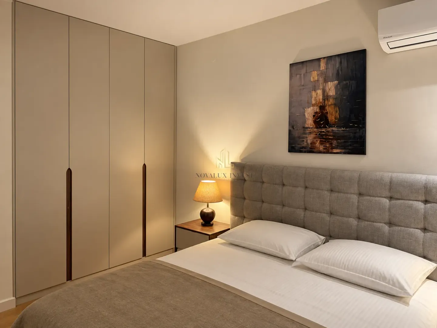Bedroom with a double bed, built-in wardrobe, and a bedside lamp.