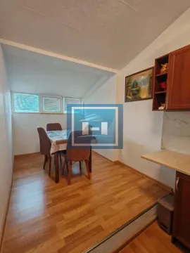 Small kitchen with a dining table and chairs. - image 4