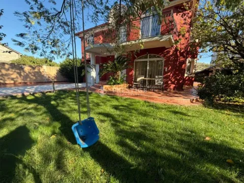 Exterior of the house with a landscaped yard, lawn and a swing. - image 3