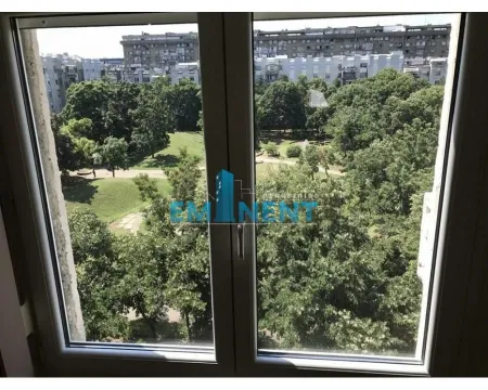 View through the window overlooking the park and greenery. - image 15