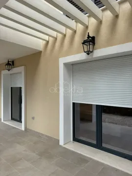Covered terrace with outdoor lighting and window shutters. - image 5