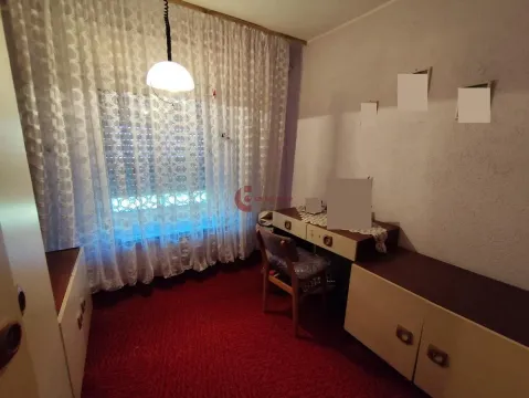 Small bedroom with a bed, desk, and window with curtains. - image 15