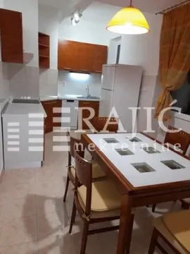 Kitchen with dining area and wooden elements. - image 11