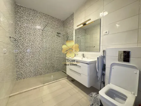 Modernly equipped bathroom with a walk-in shower and vanity. - image 10