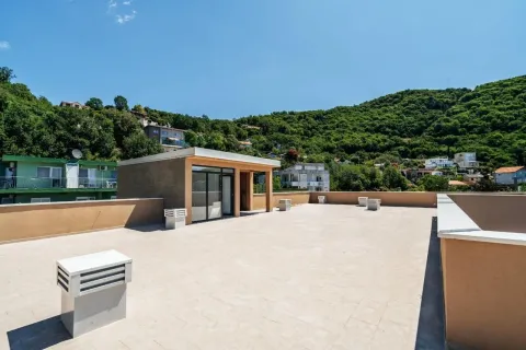 Spacious flat roof terrace of the building with a view of the surrounding greenery. - image 3