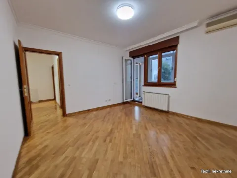 Empty room with wooden flooring, window and a door leading to the terrace. - image 9