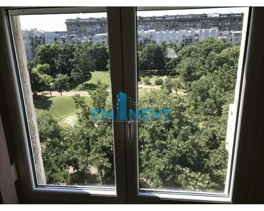 View through the window overlooking the park and greenery.