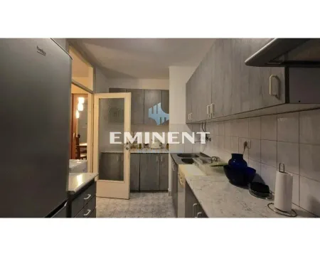 Small kitchen with wooden-patterned cabinets and a countertop. - image 7