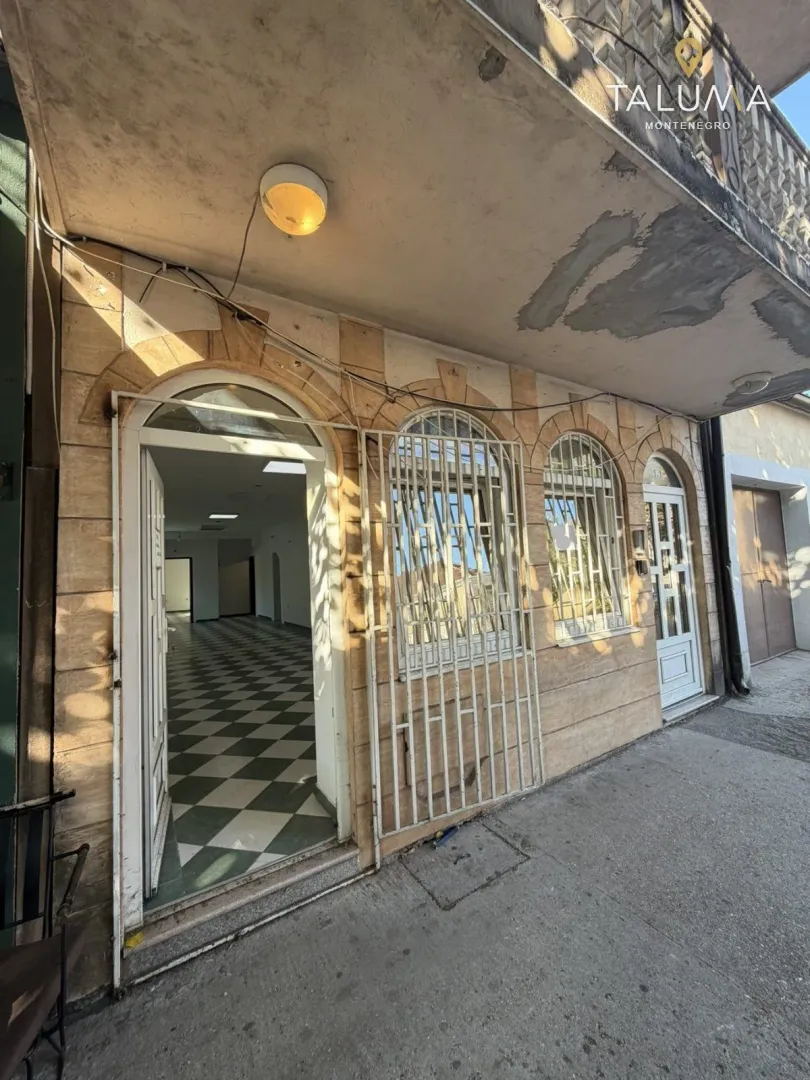 View of the exterior of the commercial space with an entrance and barred windows.