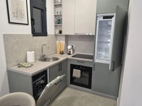 Modern kitchen with grey cabinets and built-in appliances. - image 3