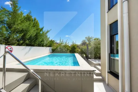 Exterior view of the courtyard with a swimming pool and part of the building facade. - image 26