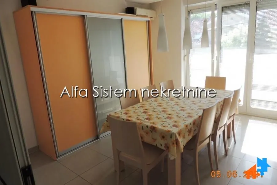 Dining area with a table, chairs, and a large wardrobe in an apartment.