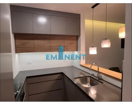 Modern kitchen with dark countertops and upper cabinets. - image 3