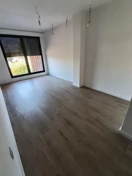 Empty unfurnished room with wooden flooring and a window. - image 20