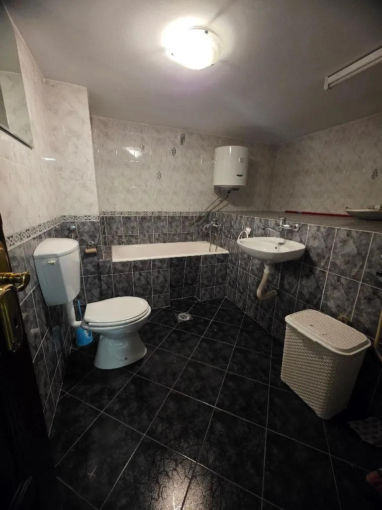 Fully equipped bathroom with a bathtub, sink, and toilet.