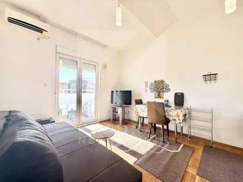 Living room with a sofa, TV, and access to the terrace. - image 3