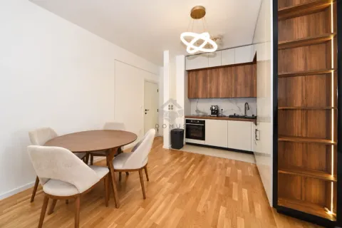 Kitchen with dining area and modern wooden elements. - image 5