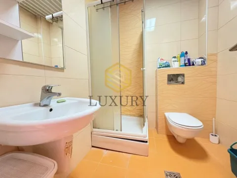 Bathroom with a sink, shower cabin, and toilet. - image 2