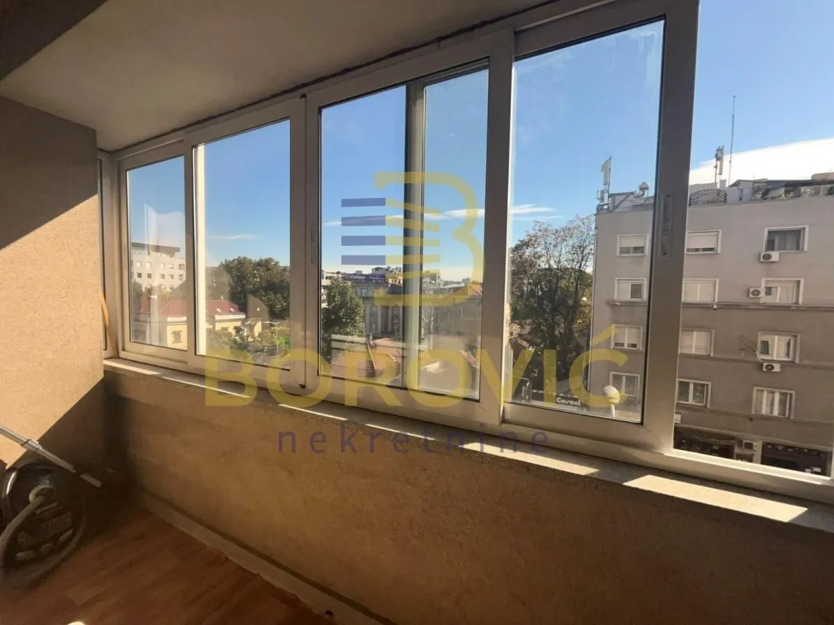 Enclosed balcony with a view of the city street.