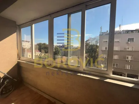 Enclosed balcony with a view of the city street. - image 6