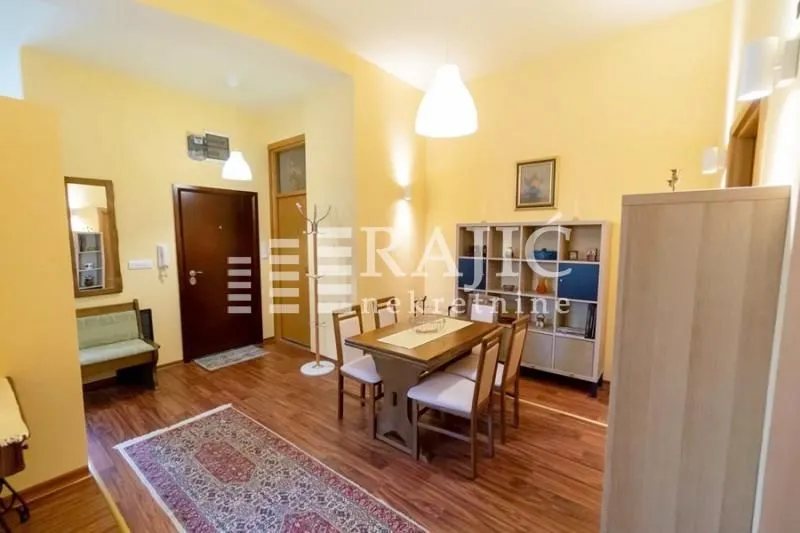 Living room with dining area and wooden furniture.