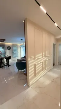 View from the hallway into the living room and dining area with modern lighting. - image 5